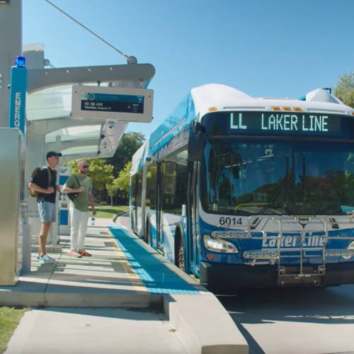bus at bus stop with waiting students